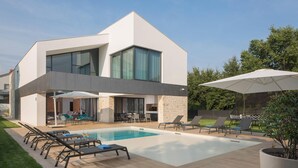 A modern two-story house with a swimming pool, outdoor seating, and a covered patio area. - Eden in Li Njan With 4 Bedrooms and 4 Bathrooms (Liznjan)