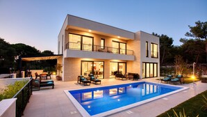 A modern two-story house with a swimming pool, outdoor seating, and a covered patio area. - Spuga in Brodarica With 4 Bedrooms and 4 Bathrooms (Sibenik)