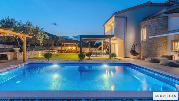 A swimming pool with a pergola and outdoor seating area, surrounded by a stone wall and trees. - Furesta in Tkon Island Pa man (Pasman)