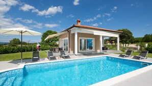 A swimming pool with lounge chairs and a covered pavilion. - Deep Blue in Labin With 3 Bedrooms and 2 Bathrooms (Labin)