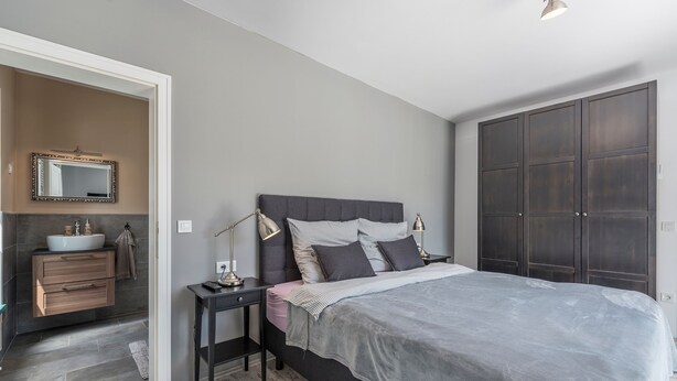 A bedroom with a large bed, bedside tables, a dresser, a mirror, and a wardrobe. - Desire in Jur i i With 4 Bedrooms and 4 Bathrooms (Svetvincenat)