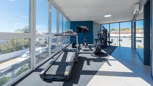 A gym with treadmills, stationary bikes, and a wall-mounted TV. - M3 in Vir With 2 Bedrooms and 2 Bathrooms (Vir)