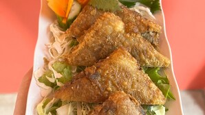A plate of fried chicken wings with lettuce and cucumber garnish. - Lapis Restaurant and Hostel (Nam Hoa Lu)