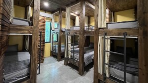 A dormitory room with bunk beds, wooden walls, and a tiled floor. - Lapis Restaurant and Hostel (Nam Hoa Lu)