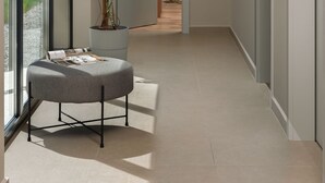 A modern hallway with a potted plant, a reading chair, and a door leading to another room. - Median in Vodnjan With 4 Bedrooms and 2 Bathrooms (Vodnjan)