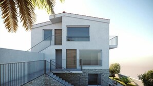 A modern multi-story building with a stone base, large windows, and a balcony. - Hrvatska in Ra anj With 6 Bedrooms and 3 Bathrooms (Rogoznica)