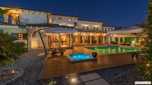 A luxurious villa with a swimming pool, outdoor seating, and a well-lit patio area. - Carolus in Barat With 5 Bedrooms and 5 Bathrooms (Visnjan)