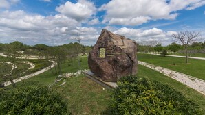 A large rock sculpture in a landscaped park with pathways and greenery. - Arkaim in Filipana With 5 Bedrooms and 5 Bathrooms (Marcana)