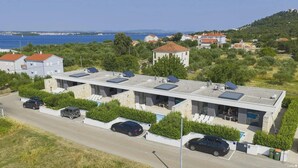 A modern building with multiple rooms, solar panels, and a pool. - K1 in Kraj With 3 Bedrooms and 1 Bathrooms (Pasman)