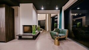 A modern living room with a sofa, coffee table, and a fireplace. - Vista Hills in Mo Enice (Moscenicka Draga)