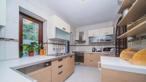 A modern kitchen with a built-in dishwasher, microwave, and oven. - Franica in Dubrovnik (Dubrovnik)