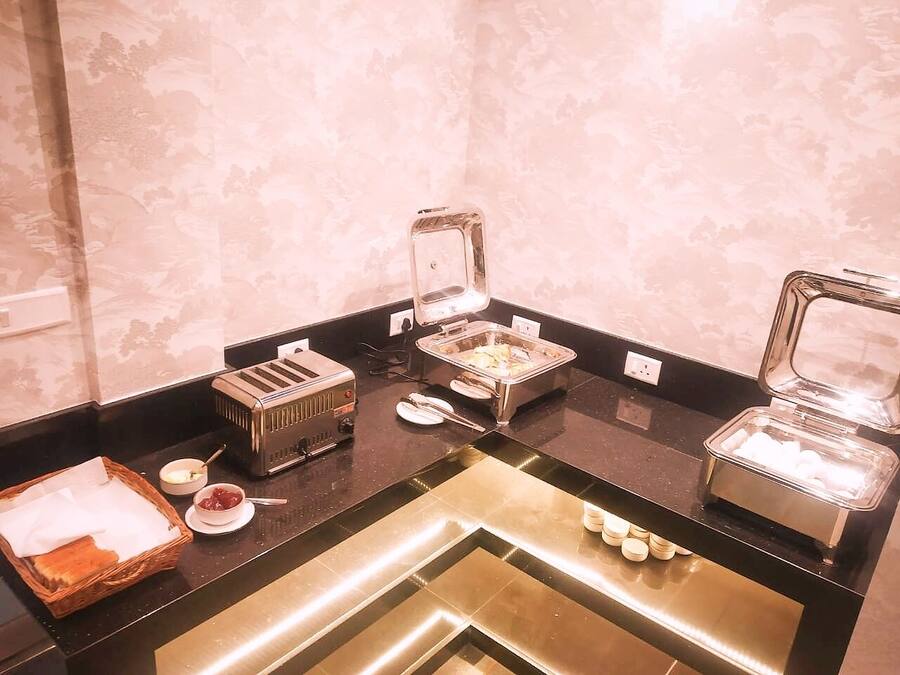 A buffet setup with various food items and appliances.