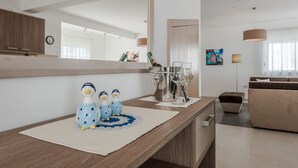 A modern living room with a wooden floor, a large mirror, a sofa, and a coffee table. - Dalmacija VII in Suko an (Sukosan)