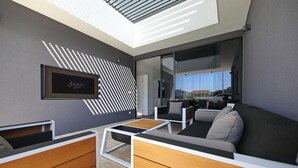 A modern interior with a sofa, a coffee table, and a framed sign on the wall. - K2 in Kraj Pa man Island (Pasman)