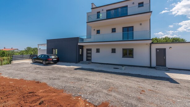 A modern multi-story building with a car parked in front. - Luna in Pomer With 6 Bedrooms and 6 Bathrooms (Medulin)