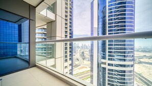 A modern hotel room with a large balcony, offering views of tall buildings and a cityscape. - Sophisticated 2BR at DAMAC Towers by Paramount A Business Bay by Deluxe Holiday Homes (Dubai)
