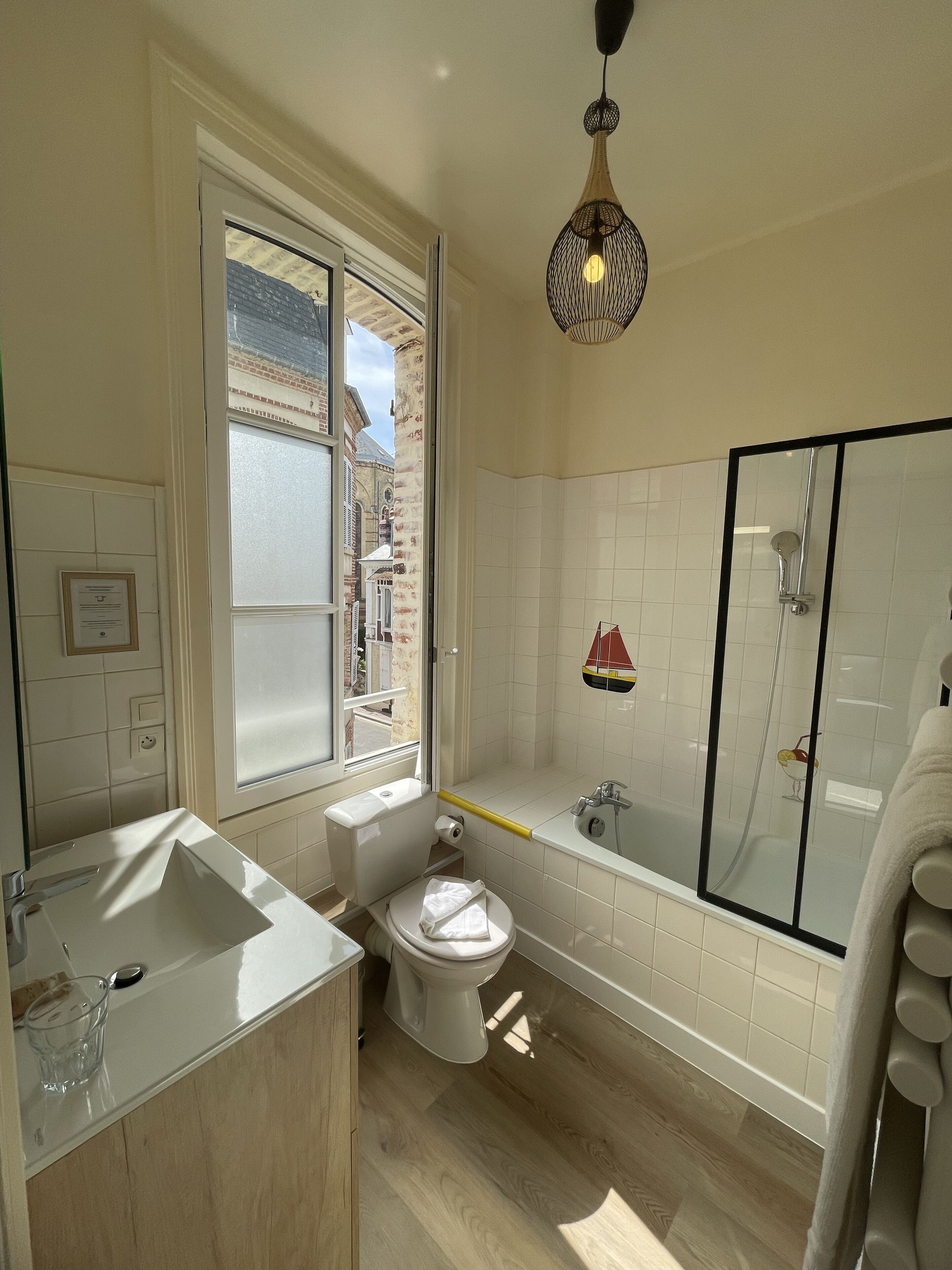 A bathroom with a bathtub, toilet, and sink.