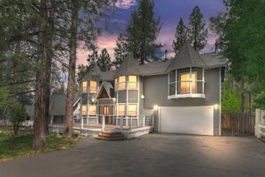 A two-story house with a garage, large windows, and a porch. - Fox Farm Family Retreat Game Room Pet-Friendly (Big Bear Lake)
