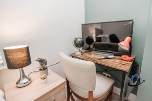 Work in comfort with a desk, flat-screen TV, and globe.