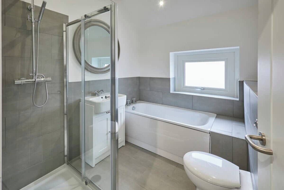 Bathtub, hair dryer, towels, shampoo