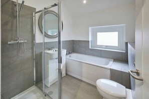 Bathtub, hair dryer, towels, shampoo