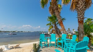 A wooden deck with turquoise chairs and a sandy beach. - The Pass 608 by Liquid Life (Orange Beach)