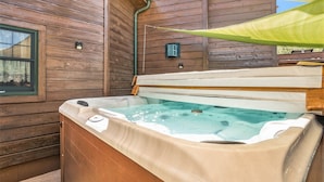 A wooden cabin with a hot tub. - Solitude Bear Room Ada 103 - Estes Park 1 Bedroom Studio by RedAwning (Estes Park)