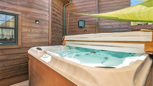 A wooden cabin with a hot tub.