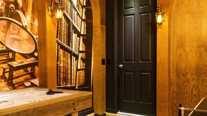 A library with bookshelves, a wooden desk, and a black door. - Last Minute Disney! Private Pool, Hot Tub, Game Room & Themed Bedrooms. Book Now! #90507 (Orlando)