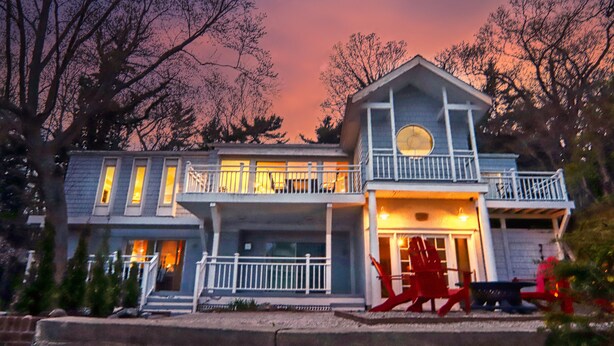 A two-story house with a balcony and a porch.