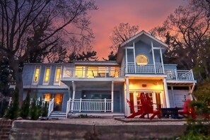 A two-story house with a balcony and a porch.