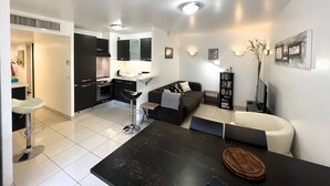 A modern apartment with a kitchen, dining area, and living room. - Sunlight Properties MIRAGE - Nice centre with parking & terrace (Nice)