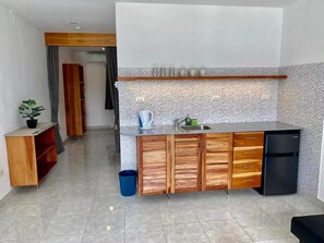 Fridge, microwave, cookware/dishes/utensils, dining tables