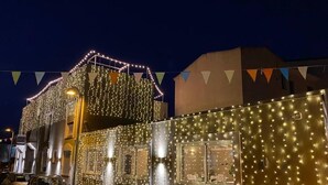 A building with string lights and a small awning. - Tabernabè (Tortoli)