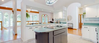 Custom, dog-friendly home on 5 lakefront acres with tennis, sauna & game room