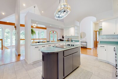 Custom, dog-friendly home on 5 lakefront acres with tennis, sauna & game room