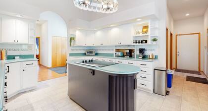 Custom, dog-friendly home on 5 lakefront acres with tennis, sauna & game room