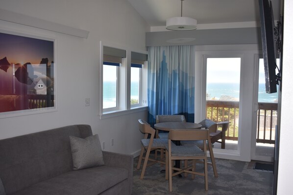 Honeymoon Studio Suite, 1 King Bed with Sofa bed, Fireplace, Ocean View | Living area | 50-inch Smart TV with cable channels, TV