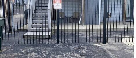 Edificio a due piani con ingresso chiuso da cancello e un cartello che indica 'RESERVE PARKING'.