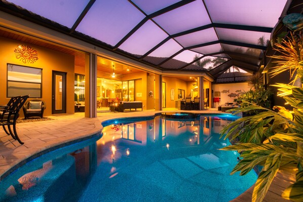 Relax by the pool surrounded by comfortable seating and natural light.