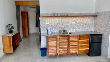 Fridge, microwave, cookware/dishes/utensils, dining tables