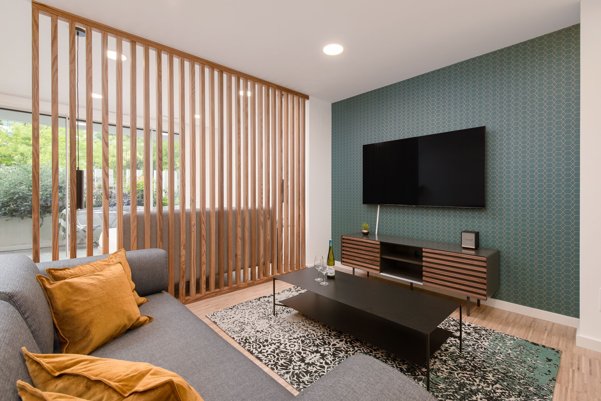 A modern living room with a sofa, coffee table, and TV.