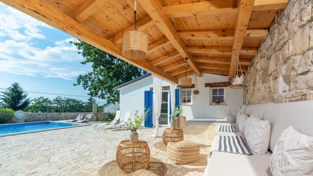A stone patio with a pool, outdoor seating, and a covered area with wooden beams. - Lavova in Brtonigla With 3 Bedrooms and 2 Bathrooms (Brtonigla)