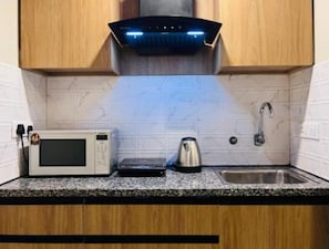 Fridge, microwave, cookware/dishes/utensils