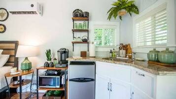 Fridge, microwave, coffee/tea maker, cookware/dishes/utensils