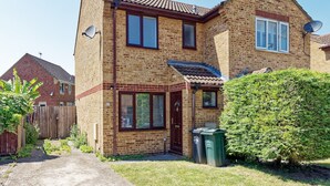 A two-story brick house with a front door, windows, and a satellite dish. - Lovely 2-bed House in Kent - Parking Available (Greenhithe)