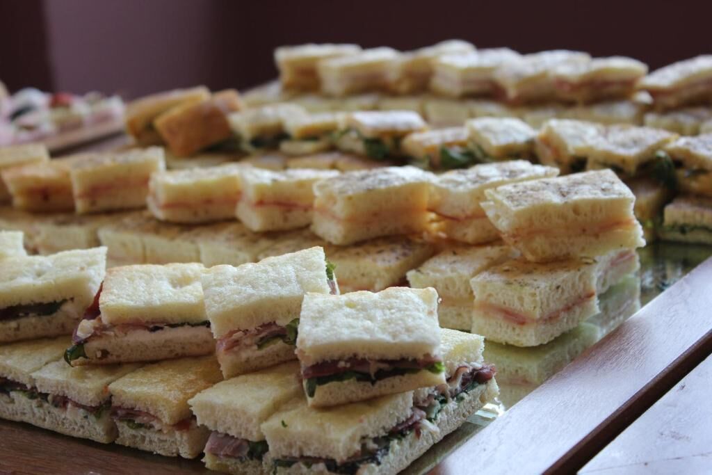A tray of sandwiches with various fillings.