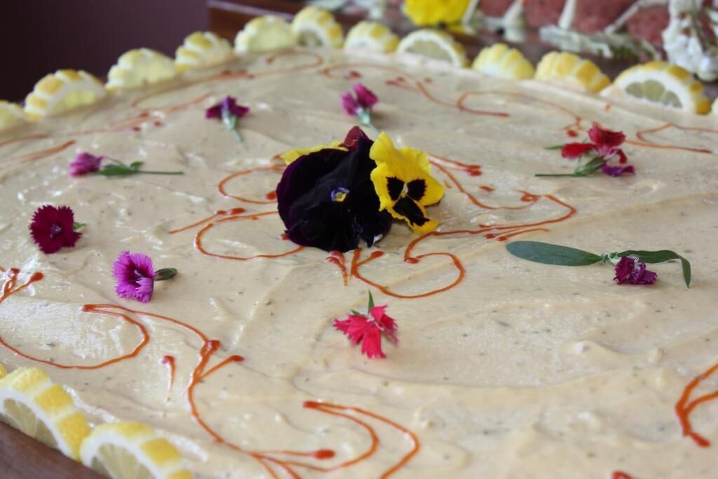 A dessert with floral decorations and drizzled sauce.