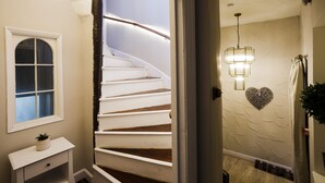 A spiral staircase with white railings and a light fixture above it. - The Admiral's Home (Whitehaven)