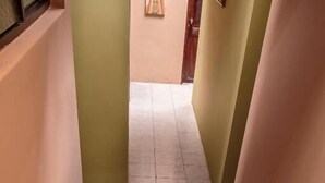 A wooden staircase with a handrail, leading to a tiled floor.